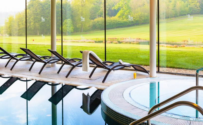 Indoor swimming pool looking out to golf course at Bowood Hotel